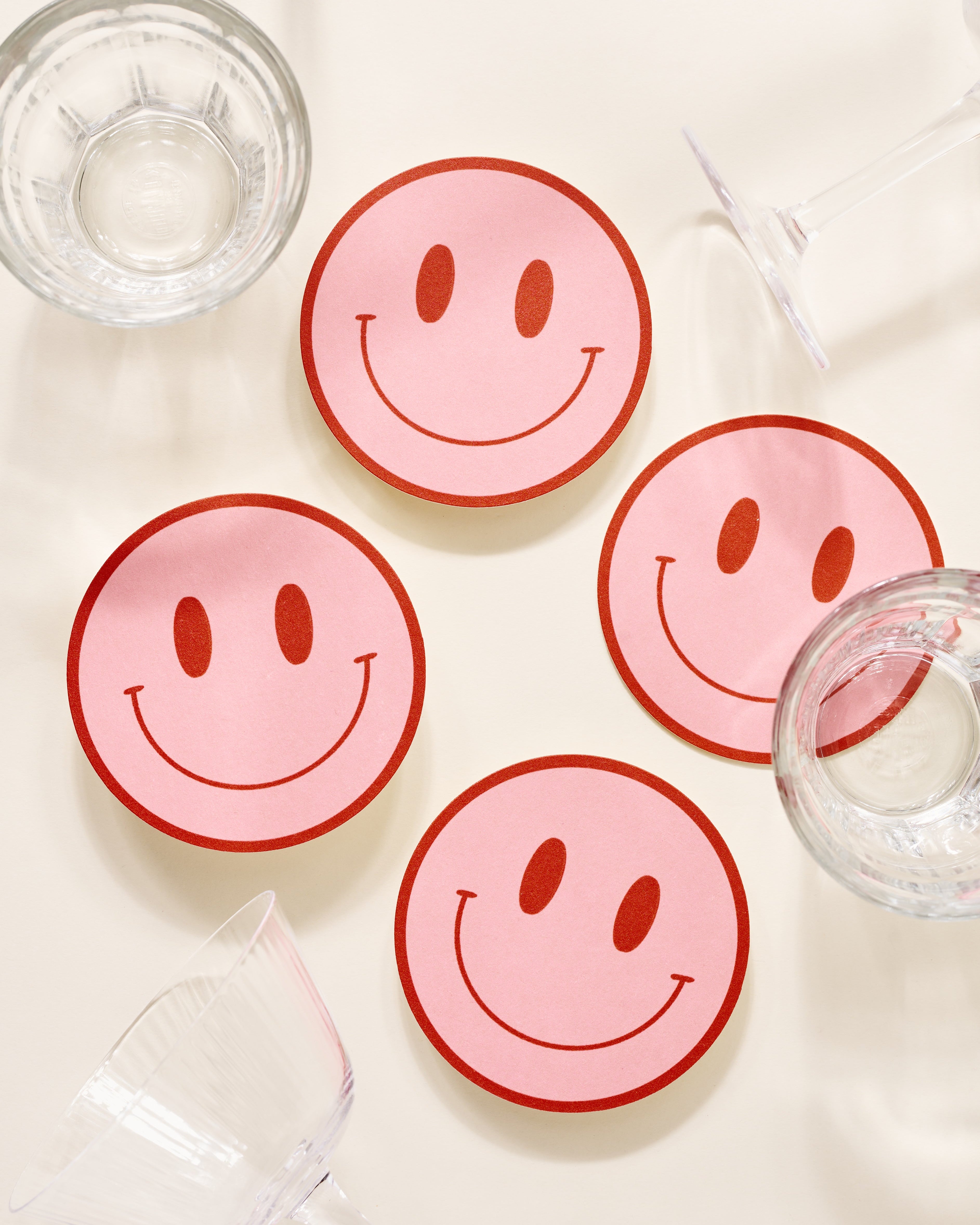 Peach and tomato smiley face coasters with retro color palette, set of four
