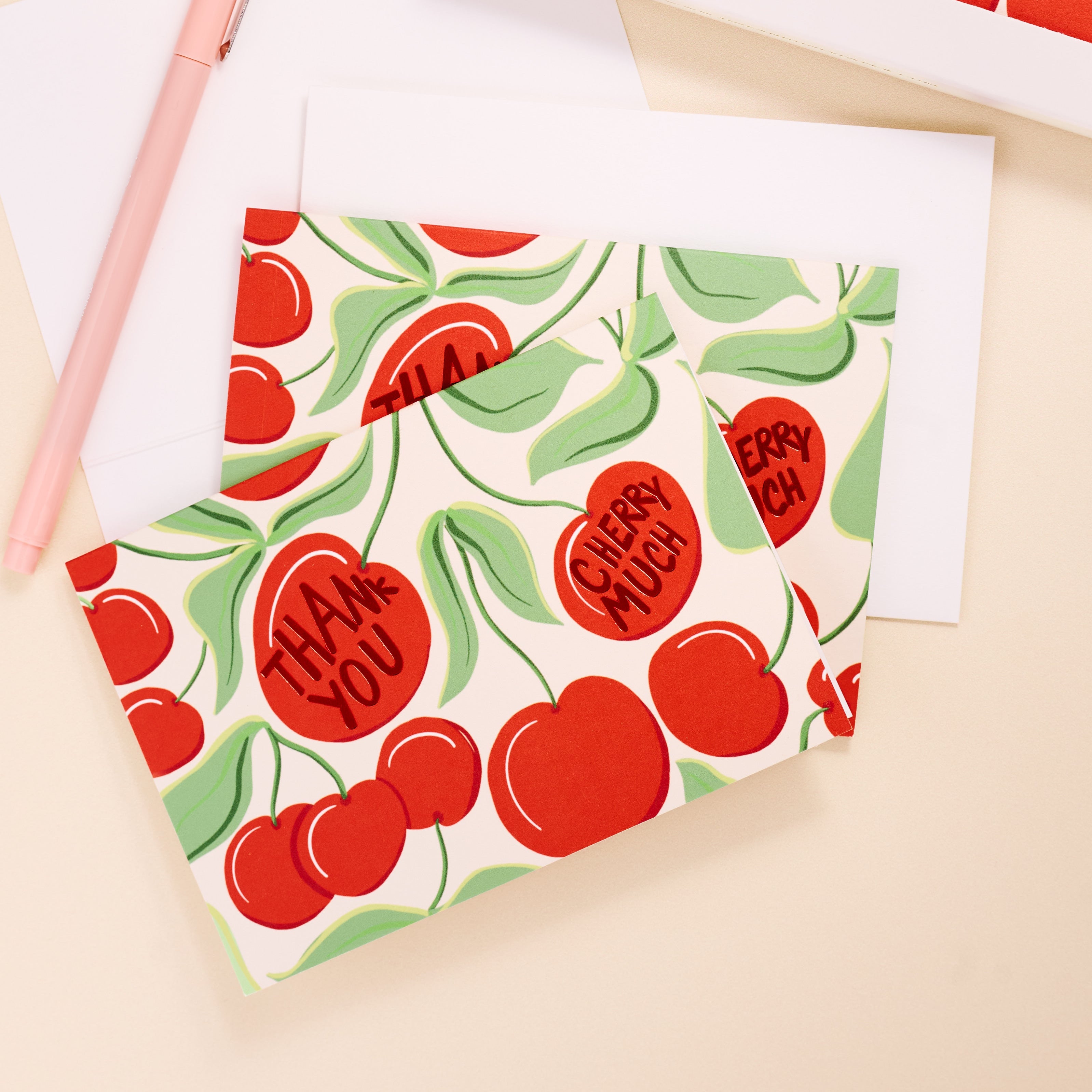 Set of greeting cards with cherry design and 'Thank You' text on a beige background
