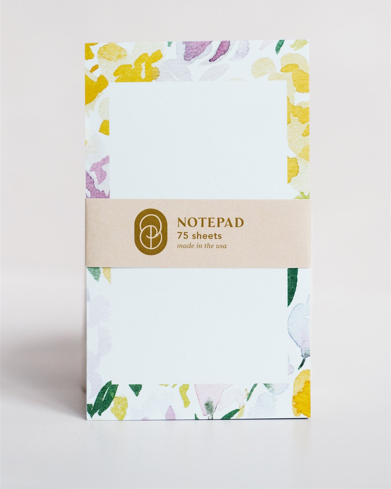 notepad with abstract floral watercolor border on light dusty pink background